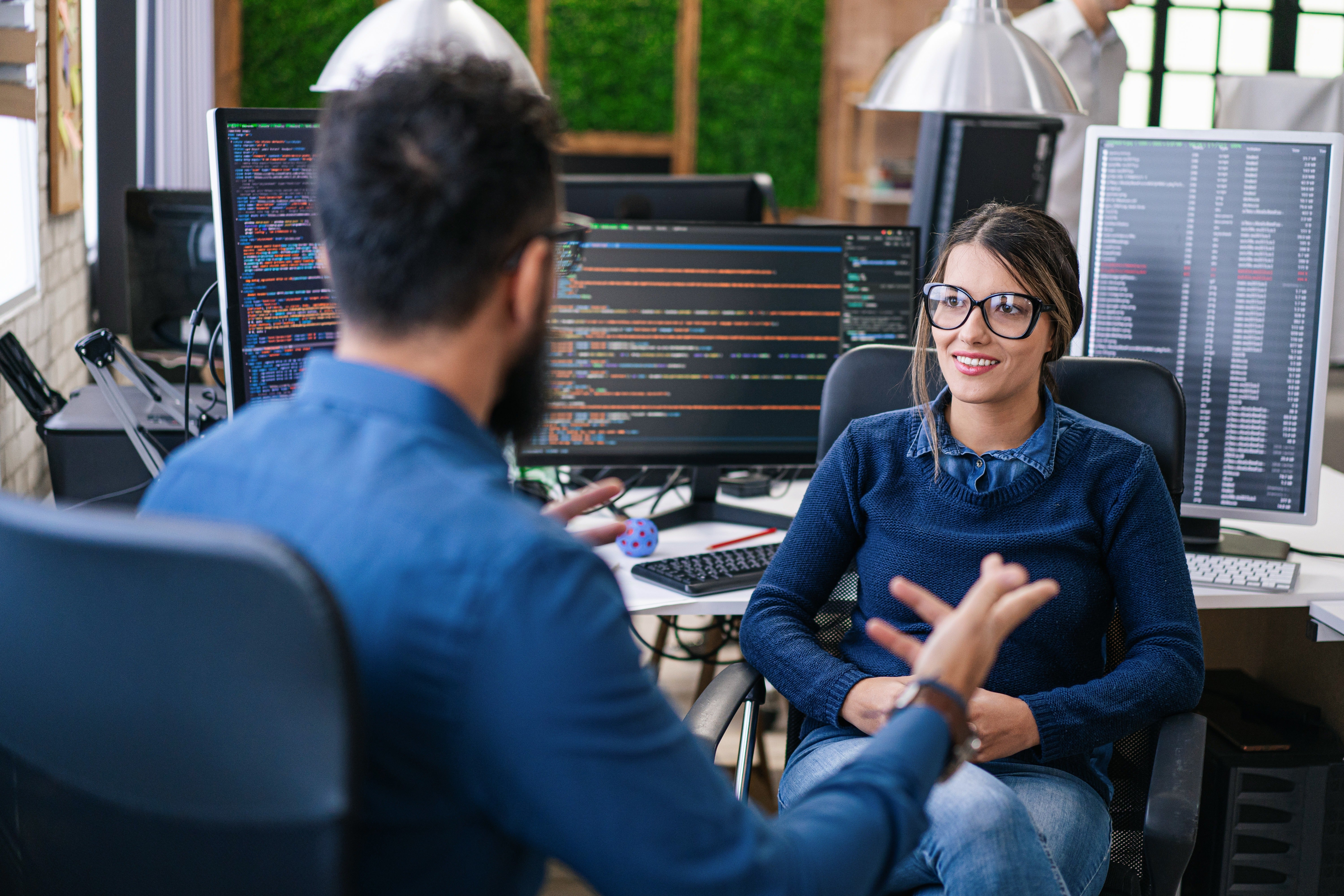 Two people having a discussion about cyber security.
