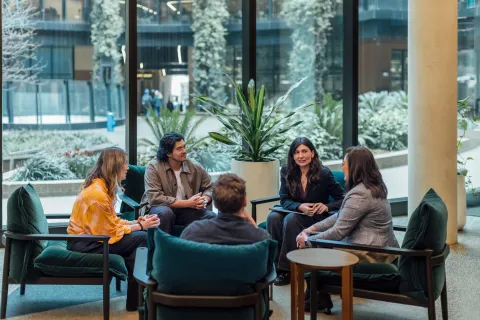 A group of five people having a casual discussion.