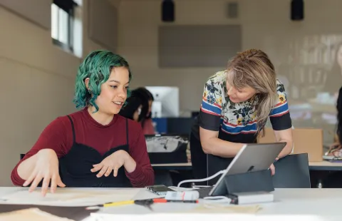 A teacher and her student engage in a discussion