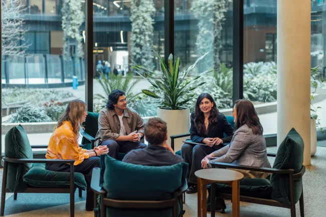 A group of five people having a casual discussion.